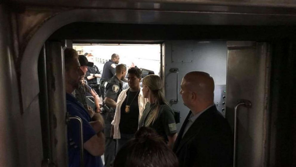 Passengers and law enforcement and transit officials on a derailed NJ Transit rail car at New York City's Penn Station on July 6, 2017.