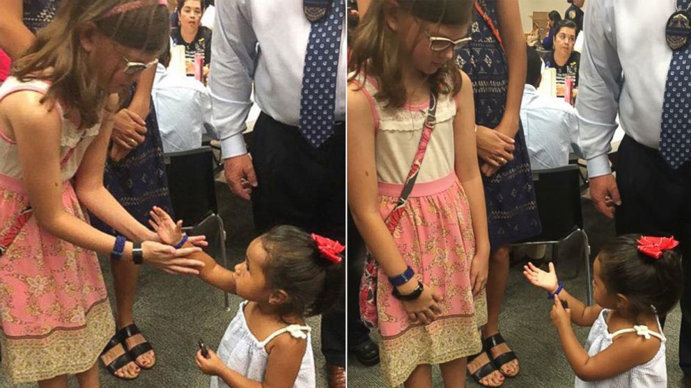PHOTO: The daughter of Sgt. Michael Smith made a bracelet for the daughter of Officer Patrick Zamarripa and gave it to her at a memorial service for their fathers and the three other Dallas officers who were killed during a protest in Dallas, Texas. 
