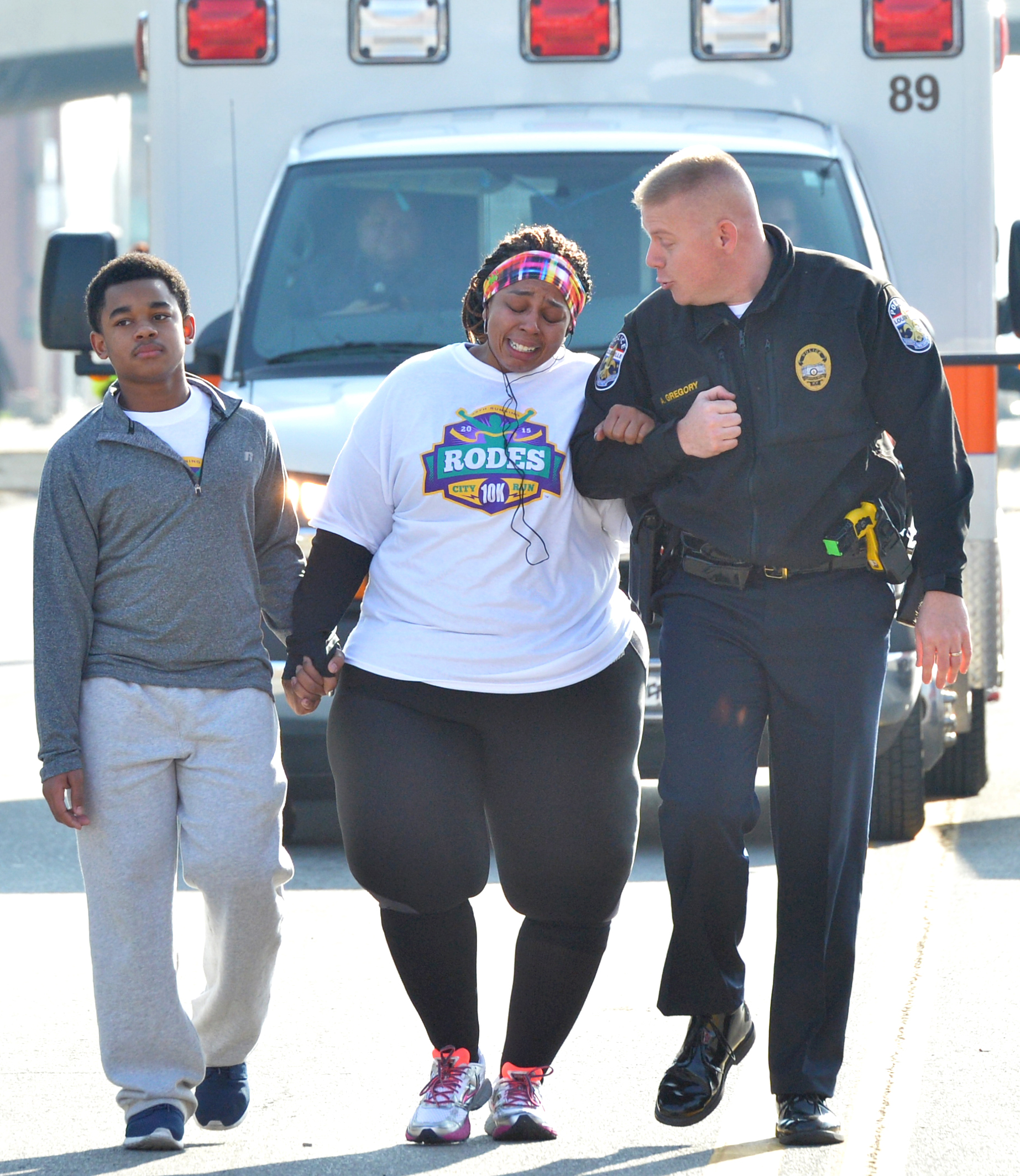 PHOTO: Police Officer Aubrey Gregory walks with Asia Ford as she participates in the Rodes City Run 10K in Louisville, Ky. on March 21, 2015.