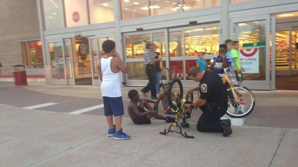 A photo of a Connecticut police officer helping fix a child's bicycle was posted on the Facebook page of the Ansonia Police Department.