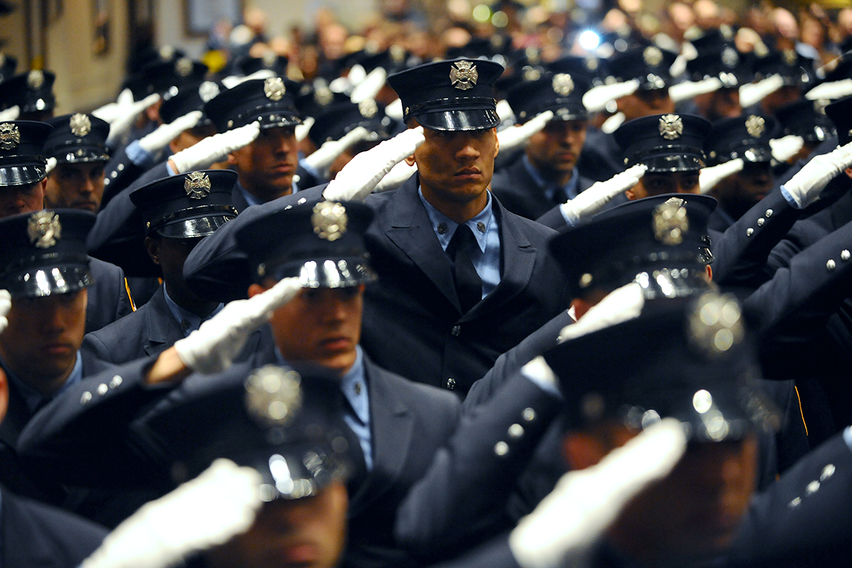 PHOTO: Newly graduated Probationary Firefighters salute at their graduation ceremony at the Christian Cultural Center in Brooklyn on Nov. 18, 2014.