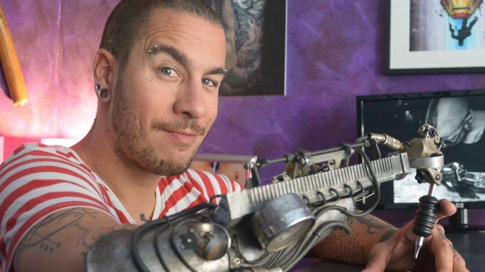 Tattoo artist JC Sheitan Tenet received a custom-designed arm prosthesis prototype that doubles as a tattoo gun on June 4, 2016, during a tattoo convention in France.