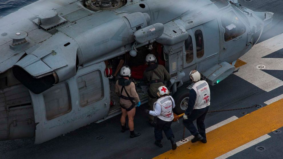 PHOTO: Sailors escort a rescued resident of French Guadalupe on the flight deck of the amphibious assault ship USS Wasp (LHD 1) following a search and rescue (SAR) mission for a private aircraft off the coast of the island Dominica on Sept. 28, 2017.