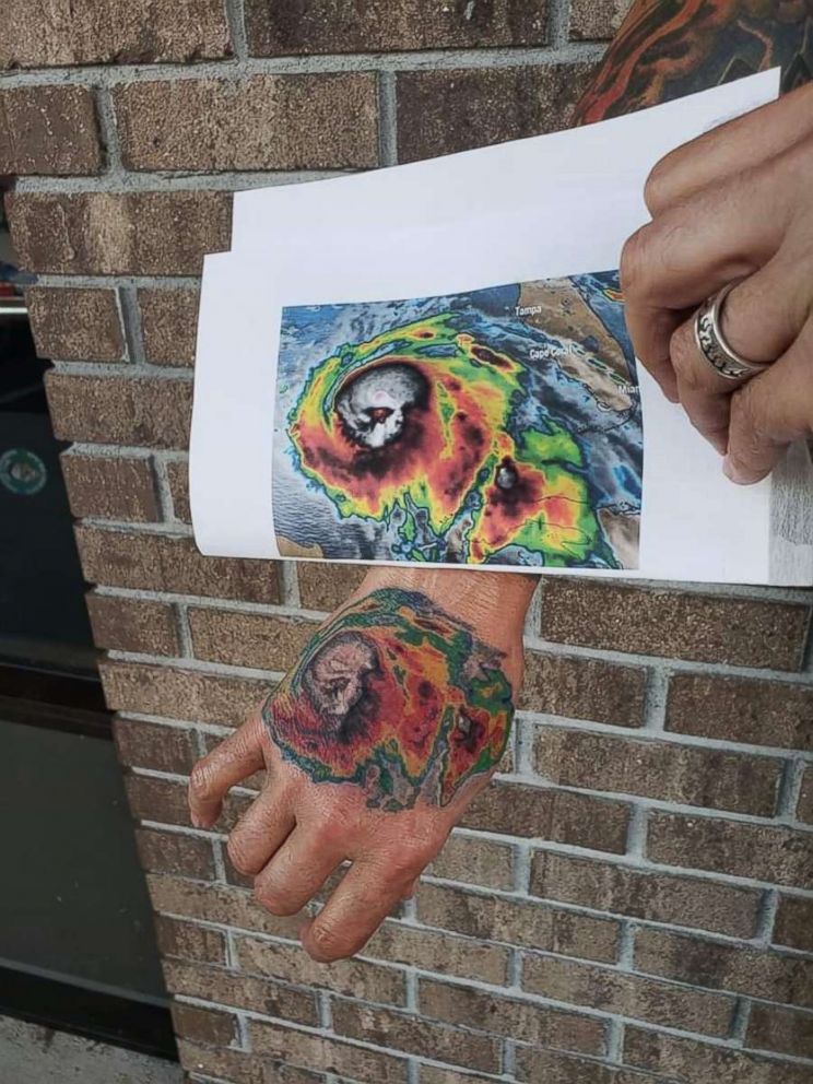 Rex Clark shows off a tattoo he got on his hand of satellite imagery of Hurricane Michael, which destroyed his Panama City home in Oct. 2018. 