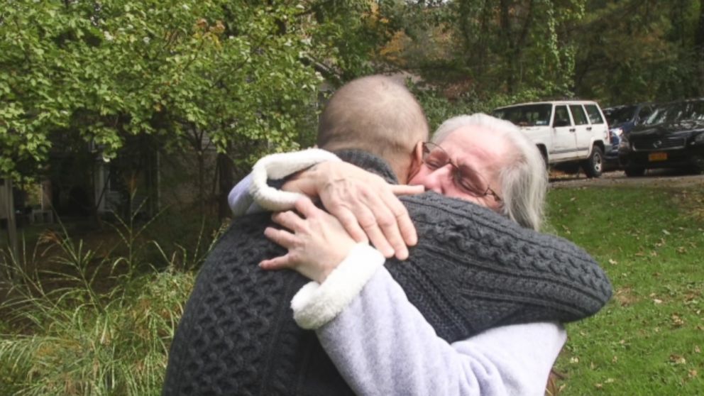 Deborah Garza and Rob Martin embrace after meeting for the first time. 