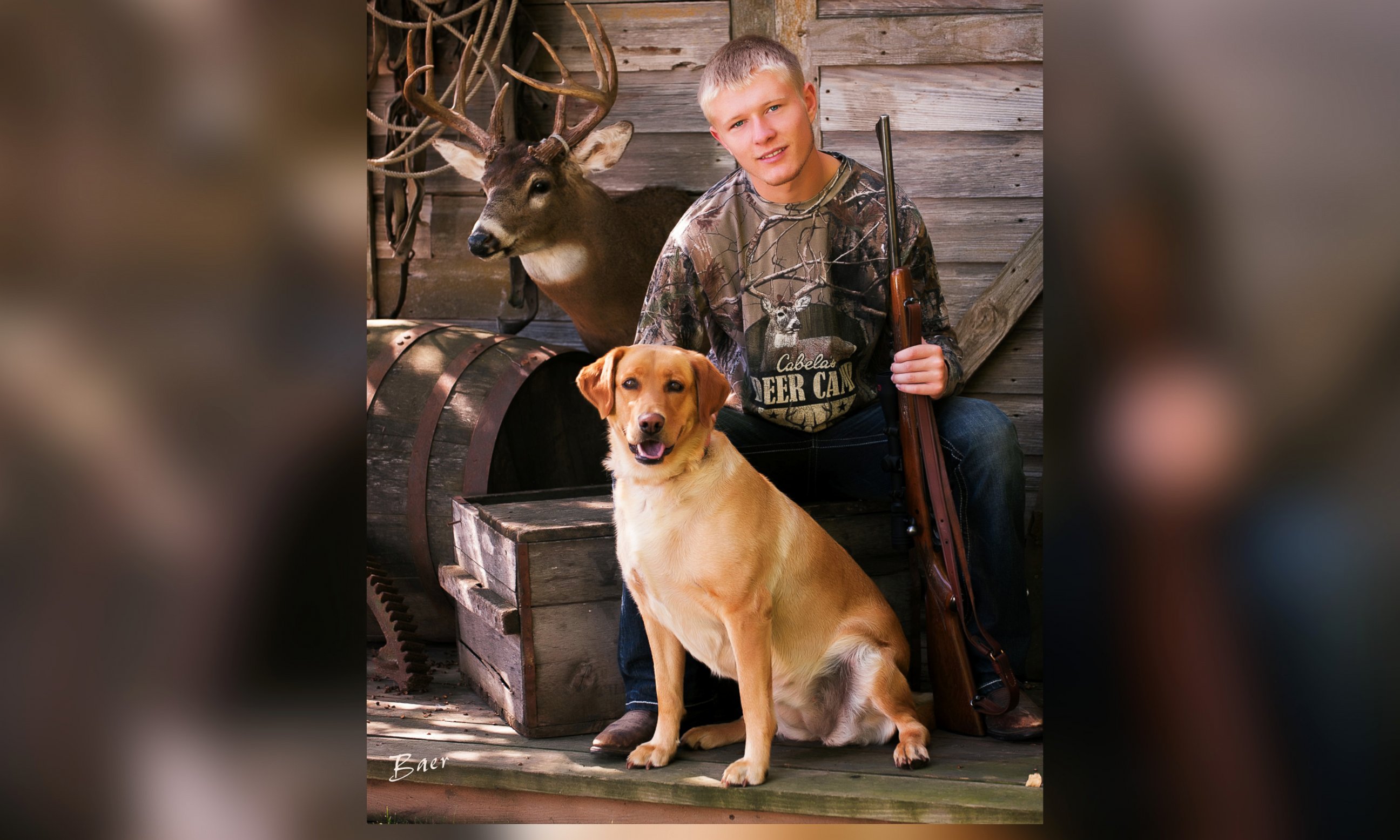 PHOTO: Nebraska senior Christian Burr poses with his dog, trophy mount and a rifle given to him by his grandfather.