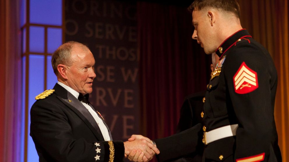 PHOTO: Marine Corps Sgt. Andrew C. Seif, right, shakes hands with the Chairman of the Joint Chiefs of Staff, Army Gen. Martin E. Dempsey, before receiving the USO Marine of the Year award during the 2013 USO Gala in Washington.