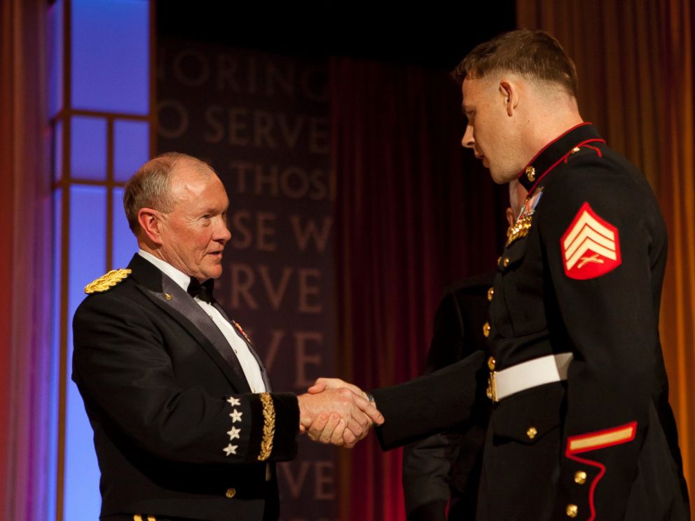 PHOTO: Marine Corps Sgt. Andrew C. Seif, right, shakes hands with the Chairman of the Joint Chiefs of Staff, Army Gen. Martin E. Dempsey, before receiving the USO Marine of the Year award during the 2013 USO Gala in Washington.