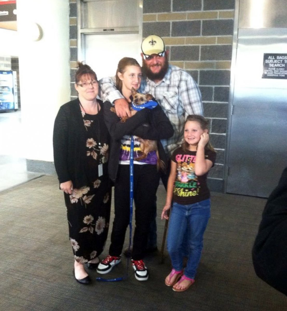 PHOTO: Surrounded by her family, Karisa Lambert holds her Yorkshire terrier that was stolen in 2012 after he was returned to the family at Louis Armstrong New Orleans International Airport in Kenner, La. on April 29, 2015.