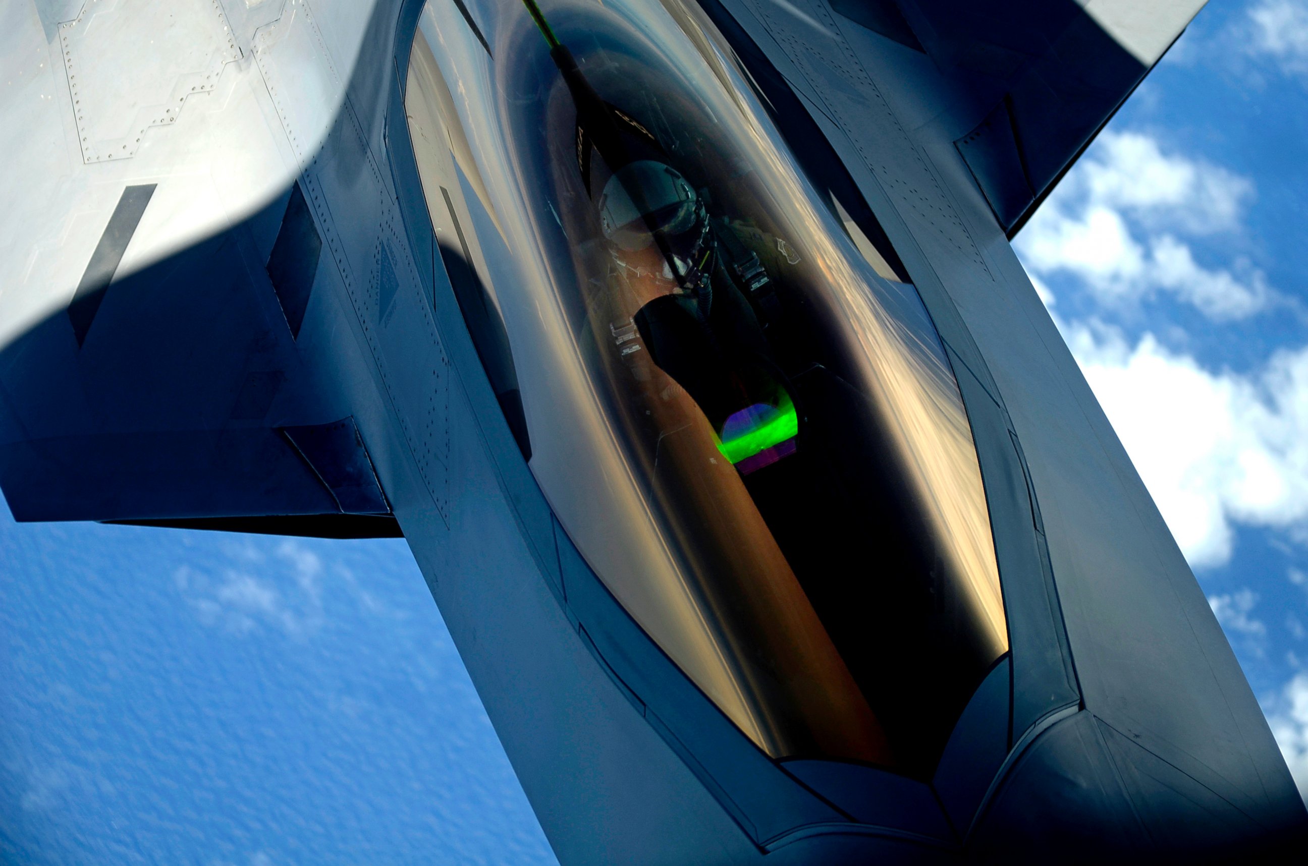 PHOTO: A U.S. Air Force F-22 Raptor aircraft with the 1st Fighter Wing receives a midair refueling from a KC-135 Stratotanker aircraft assigned to the 756th Air Refueling Wing over Joint Base Andrews in Maryland July 10, 2012.