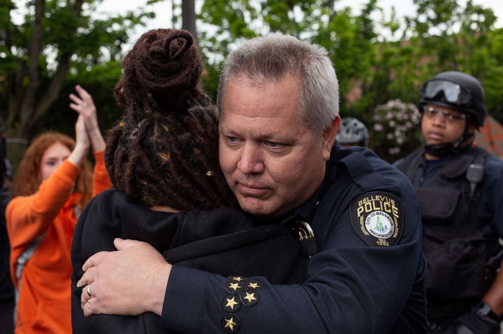 PHOTO: Bellevue Police Chief Steve Mylett hugs a demonstrator during a gathering to protest the recent death of George Floyd, May 31, 2020, in Bellevue, Washington.