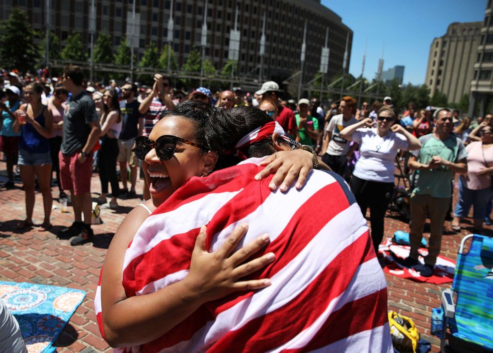 PHOTO: Two women hug during a watch party at Boston City Hall Plaza where hundreds gathered in Boston to watch the U.S. Women's soccer team play the Netherlands in the 2019 Women's World Cup Final, July 7, 2019.