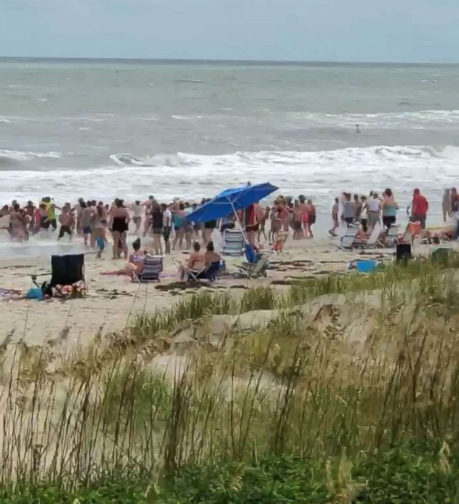 PHOTO: Beach-goers in Emerald Isle, North Carolina, formed a human chain to help get swimmers out of the rough surf.