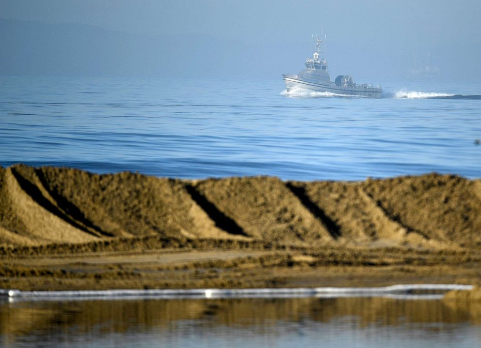 PHOTO: Boats help clean up an oil spill in Huntington Beach, California, Oct. 3, 2021.