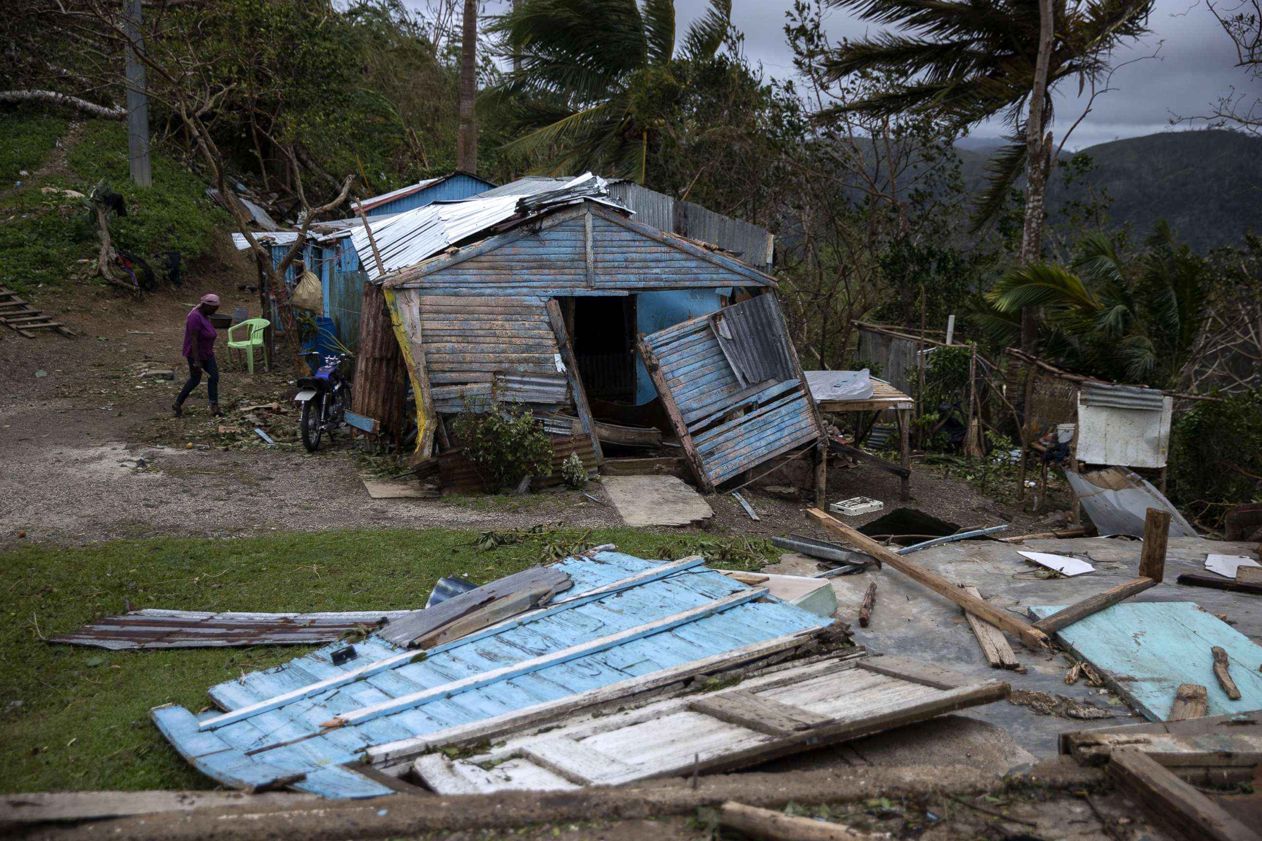 PHOTO: A woman walks next to her home, damaged by Hurricane Fiona, in Miches, Dominican Republic, Sept. 20, 2022.