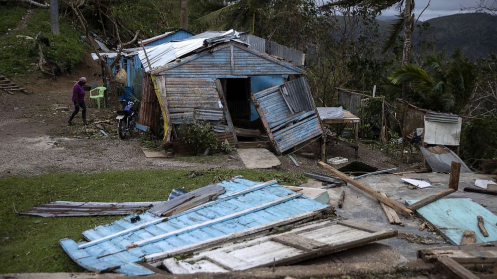 PHOTO: A woman walks next to her home, damaged by Hurricane Fiona, in Miches, Dominican Republic, Sept. 20, 2022.