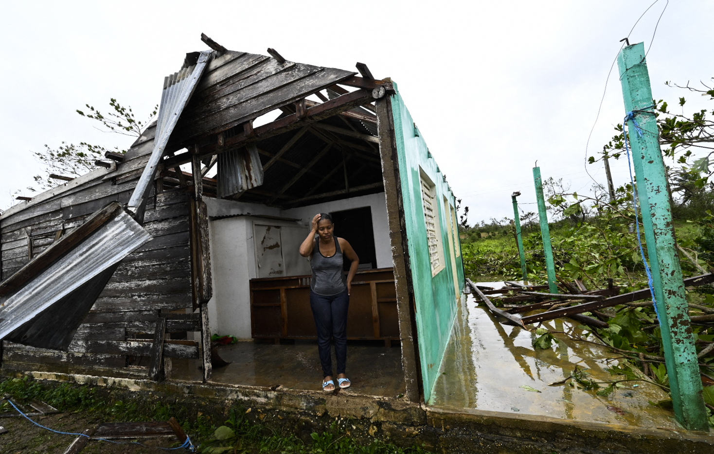 PHOTO: Caridad Alvarez stands in her house destroyed by Hurricane Ian, in San Juan y Martinez, Pinar del Rio Province, Cuba, Sept. 27, 2022.