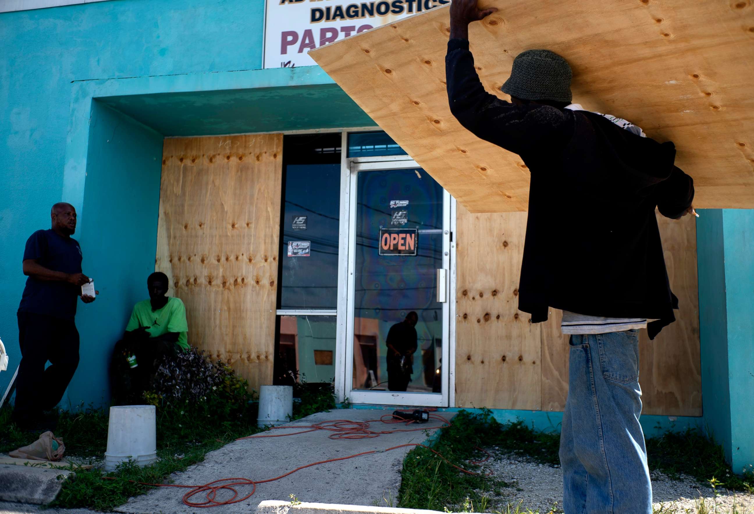PHOTO: Workers board up a shop window front as they make preparations for the arrival of Hurricane Dorian, in Freeport, Bahamas, Friday, Aug. 30, 2019.