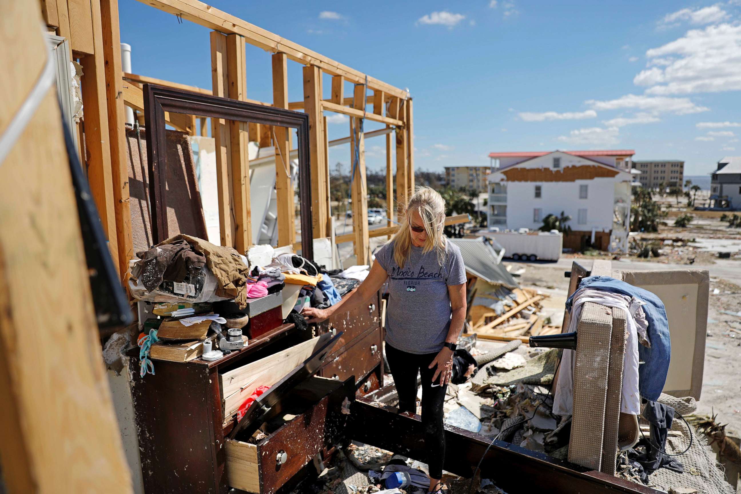 PHOTO: Candace Phillips sifts through what was her third-floor bedroom while returning to her damaged home in Mexico Beach, Fla., Oct. 14, 2018, in the aftermath of Hurricane Michael. 
