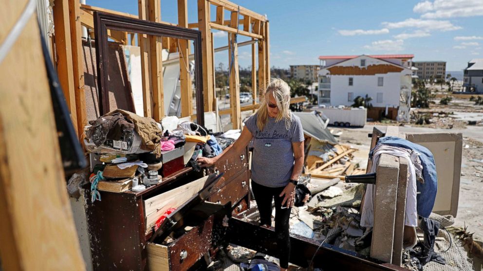 PHOTO: Candace Phillips sifts through what was her third-floor bedroom while returning to her damaged home in Mexico Beach, Fla., Oct. 14, 2018, in the aftermath of Hurricane Michael.