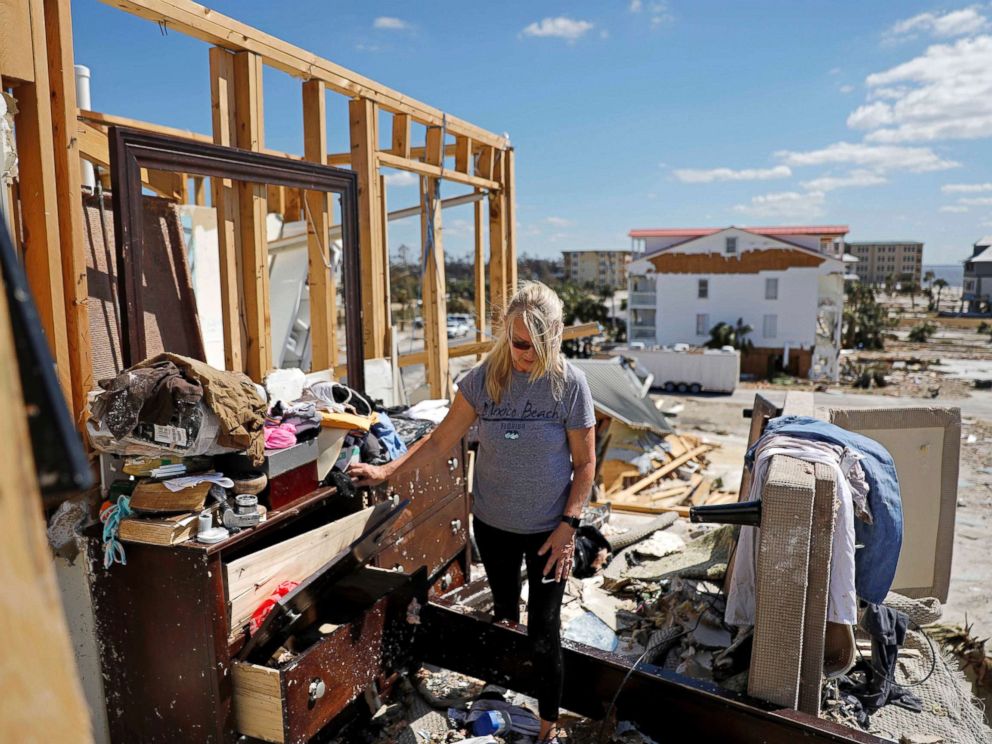 PHOTO: Candace Phillips sifts through what was her third-floor bedroom while returning to her damaged home in Mexico Beach, Fla., Oct. 14, 2018, in the aftermath of Hurricane Michael.