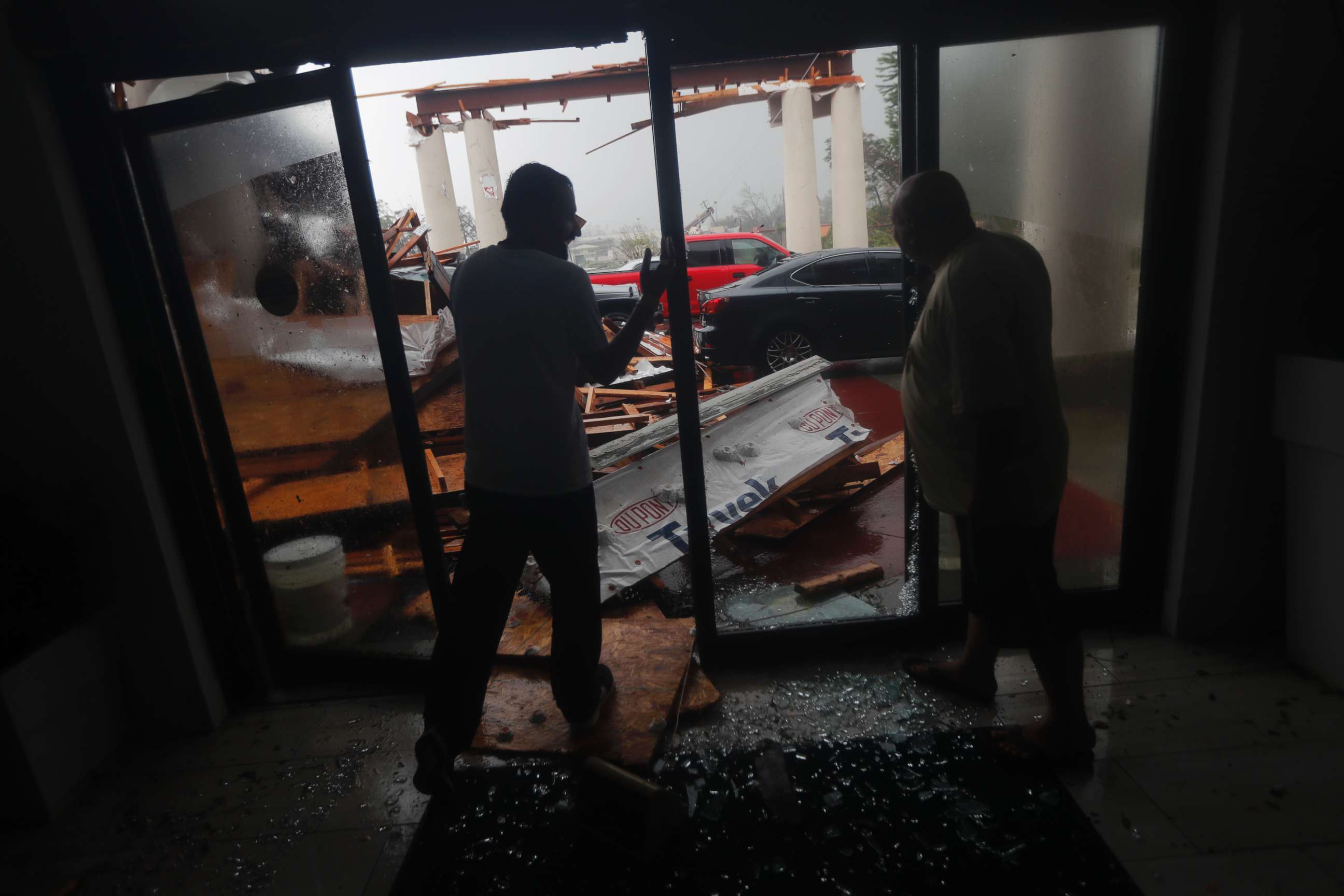 PHOTO: Hotel employees look at a canopy that just collapsed, as Hurricane Michael passes through in Panama City Beach, Fla., Oct. 10, 2018.