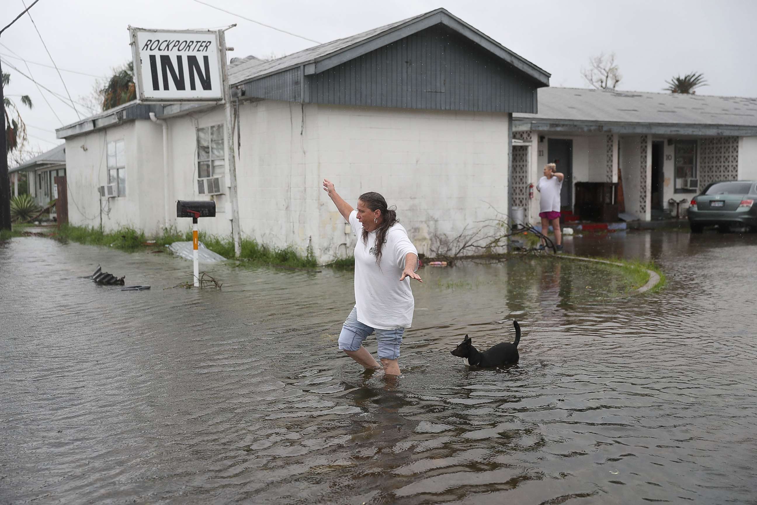 PHOTO: Valerie Brown walks through a flooded area after leaving the apartment that she road out Hurricane Harvey in, Aug. 26, 2017, in Rockport, Texas. 