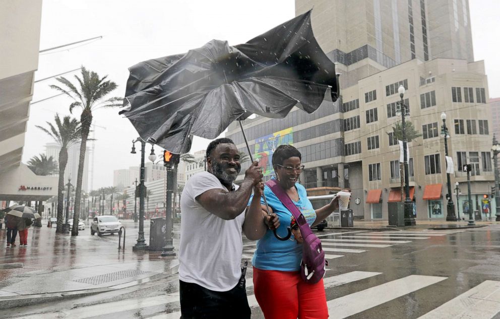 PHOTO: People battle the wind and rain from Hurricane Barry as it nears landfall in New Orleans, July 13, 2019.