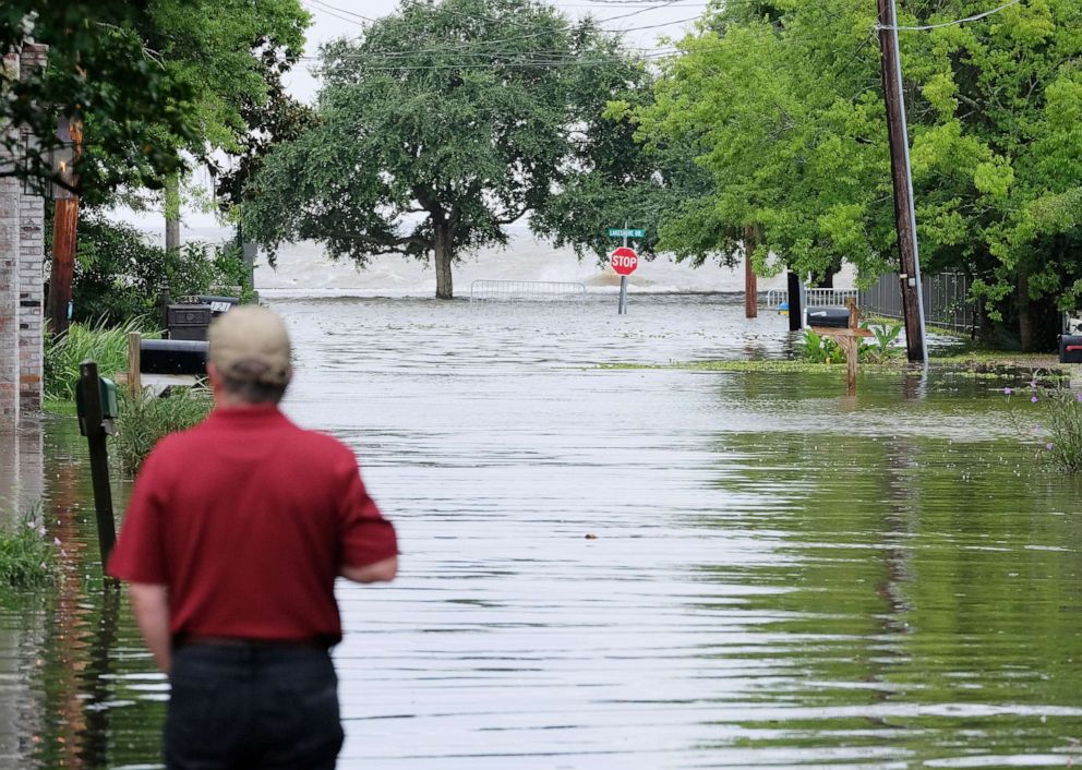 PHOTO: A man looks out at a flooded road towards Lake Pontchartrain as Tropical Storm Barry approaches in Mandeville, La., July 13, 2019.