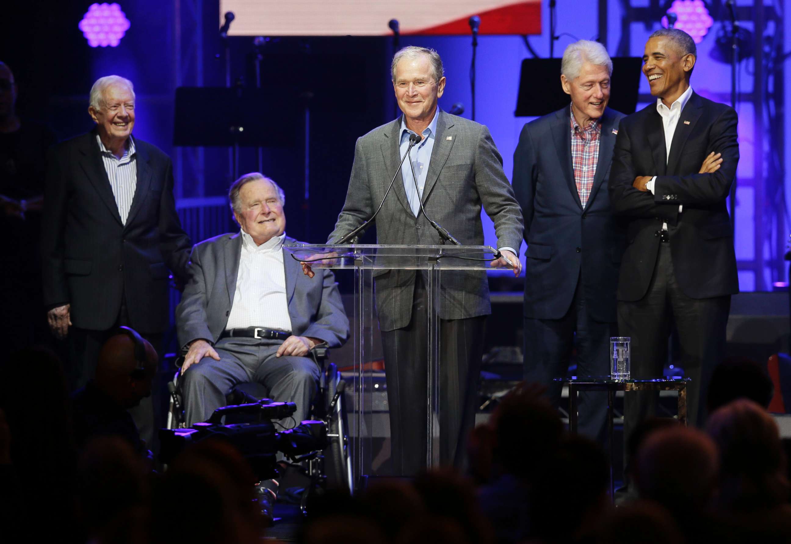 PHOTO: Former President George W. Bush, center, speaks as fellow former Presidents from right, Barack Obama, Bill Clinton, George H.W. Bush and Jimmy Carter look on during a hurricanes relief concert in College Station, Texas, Oct. 21, 2017.