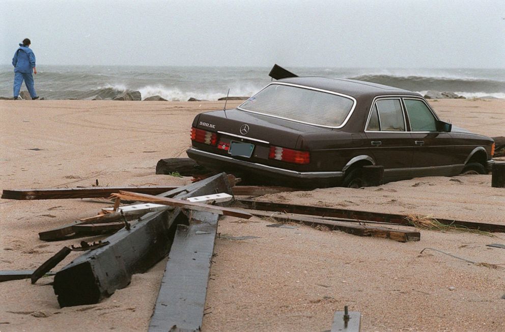 PHOTO: In this July 12, 1996, file photo, a car lies buried in the sand on Canal Drive in Carolina Beach, N.C., after Hurricane Bertha passed through the area. The car is on what was earlier a paved street.