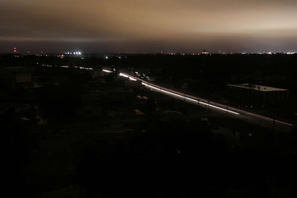 PHOTO: Cars move through a section of the city suffering a power outage during Hurricane Delta on Oc. 9, 2020 in Lafayette, La. Hurricane Delta made landfall as a Category 2 storm in Louisiana today leaving some 300,000 customers without power.