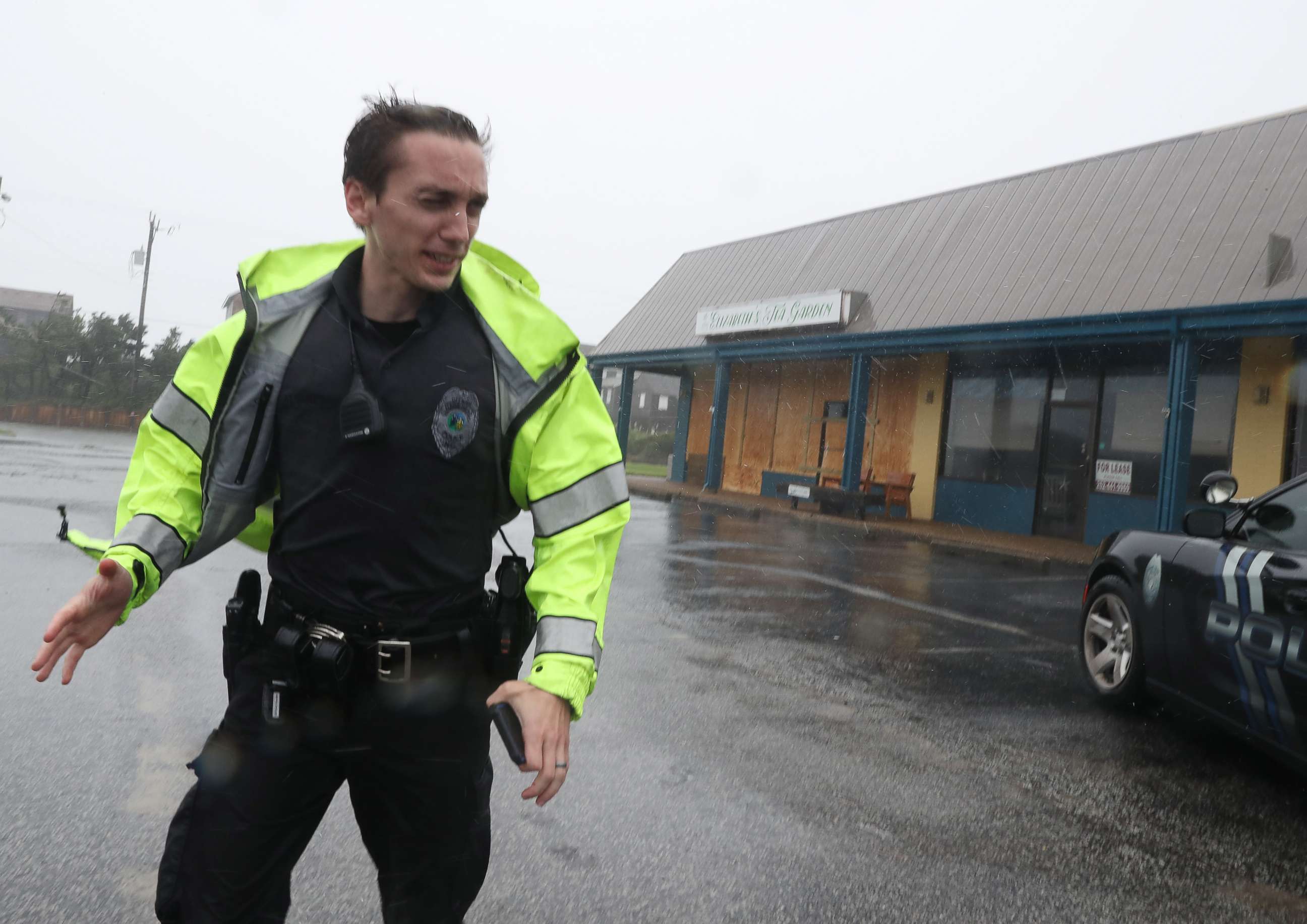 PHOTO: A police officer inspects a shopping center for damage after Hurricane Dorian hit the area, on Sept. 6, 2019 in Nags Head, N.C.