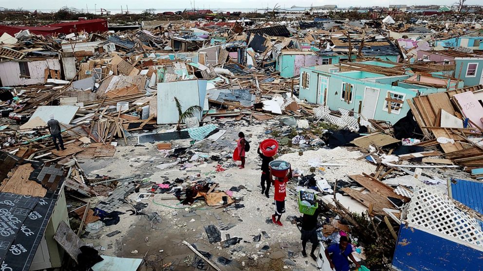 PHOTO: People search for salvageable items as they make their way through an area destroyed by Hurricane Dorian at Marsh Harbour in Great Abaco Island, Bahamas on Thursday, Sept. 5, 2019.