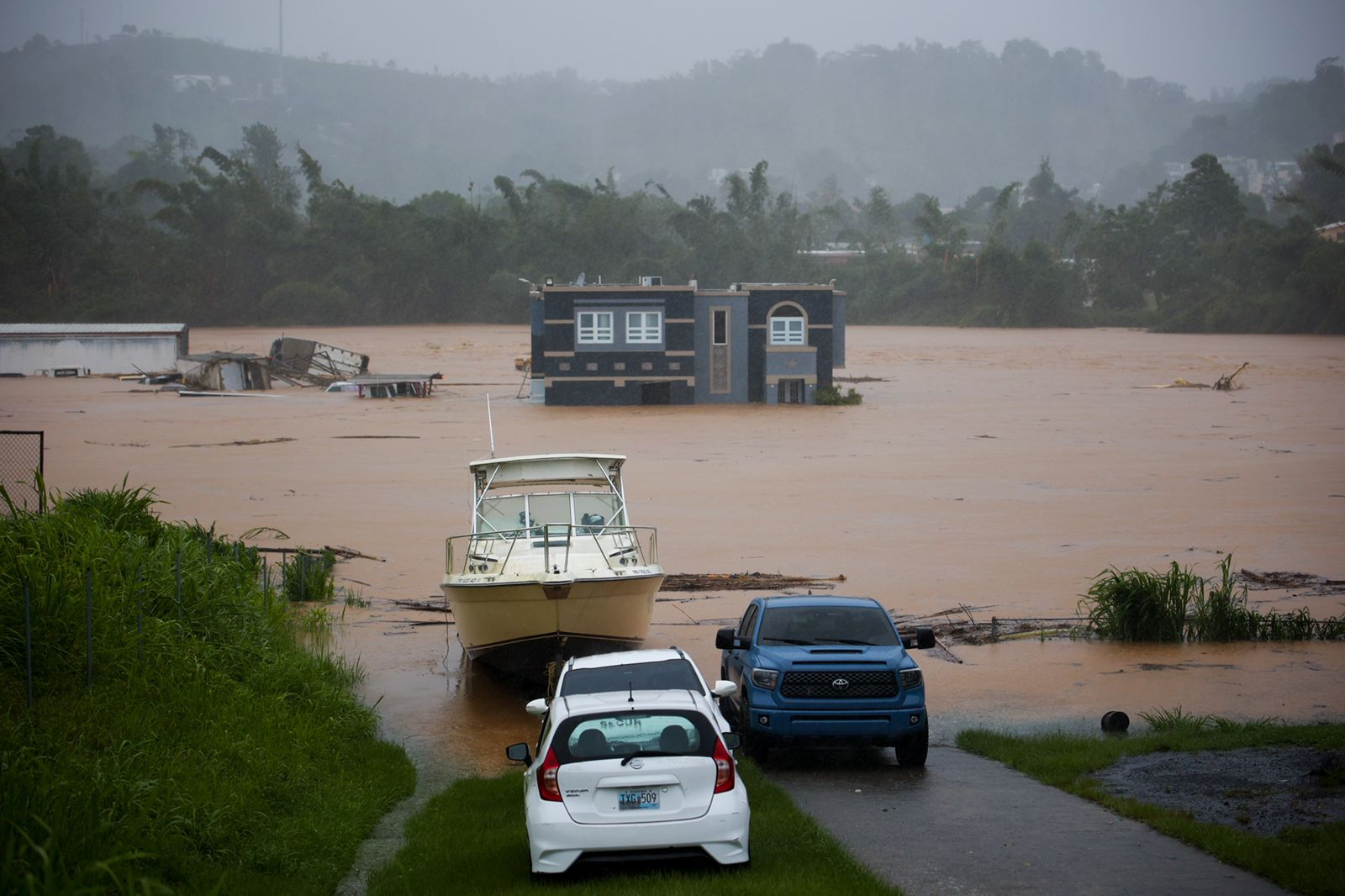 PHOTO: People inside a house await rescue from the floods caused by Hurricane Fiona in Cayey, Puerto Rico, on Sept. 18, 2022.