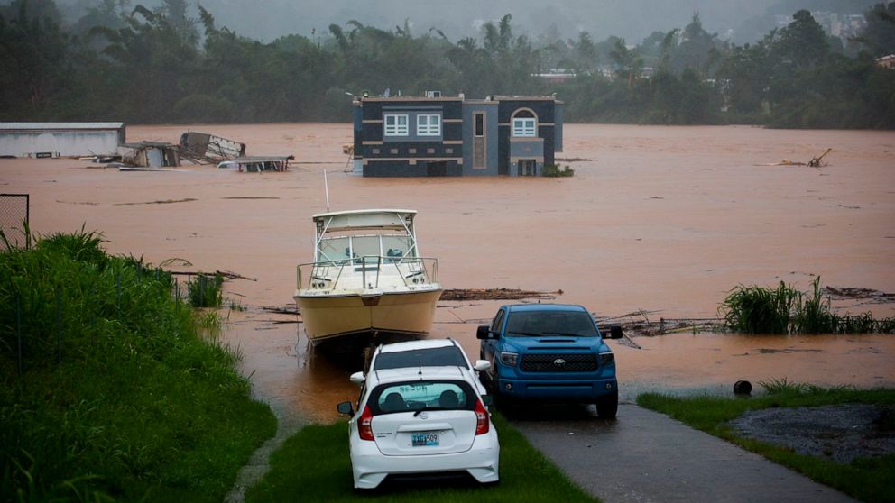 PHOTO: People inside a house await rescue from the floods caused by Hurricane Fiona in Cayey, Puerto Rico, on Sept. 18, 2022.