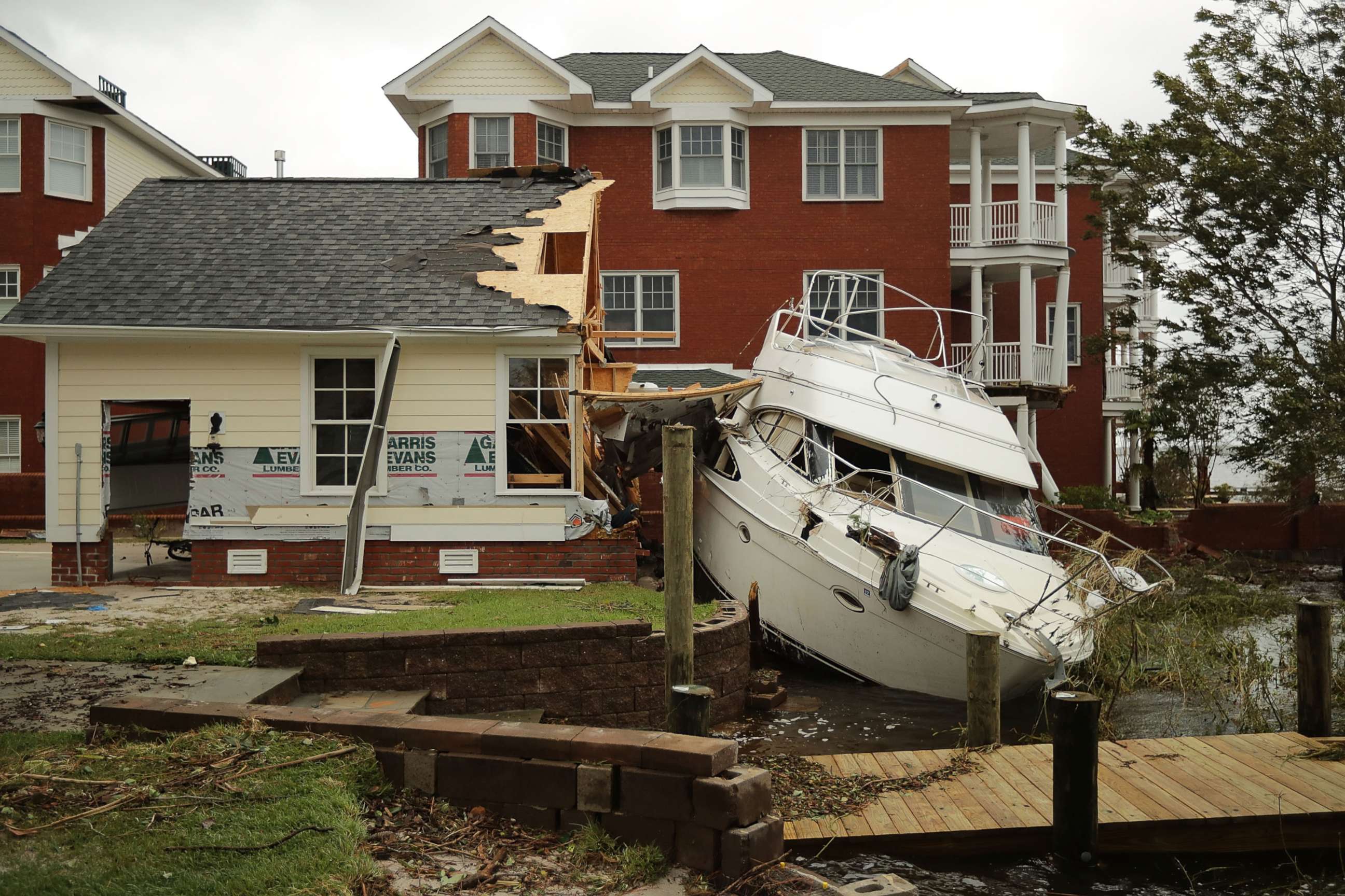 PHOTO: A boat lays smashed against a car garage, deposited there by the high winds and storm surge from Hurricane Florence along the Neuse River, Sept. 15, 2018, in New Bern, N.C.
