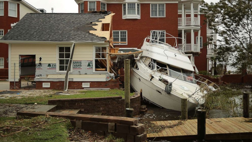 PHOTO: A boat lays smashed against a car garage, deposited there by the high winds and storm surge from Hurricane Florence along the Neuse River, Sept. 15, 2018, in New Bern, N.C.