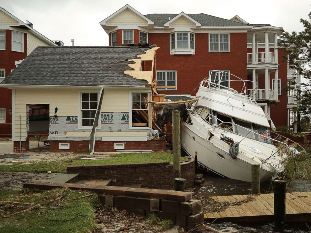 PHOTO: A boat lays smashed against a car garage, deposited there by the high winds and storm surge from Hurricane Florence along the Neuse River, Sept. 15, 2018, in New Bern, N.C.