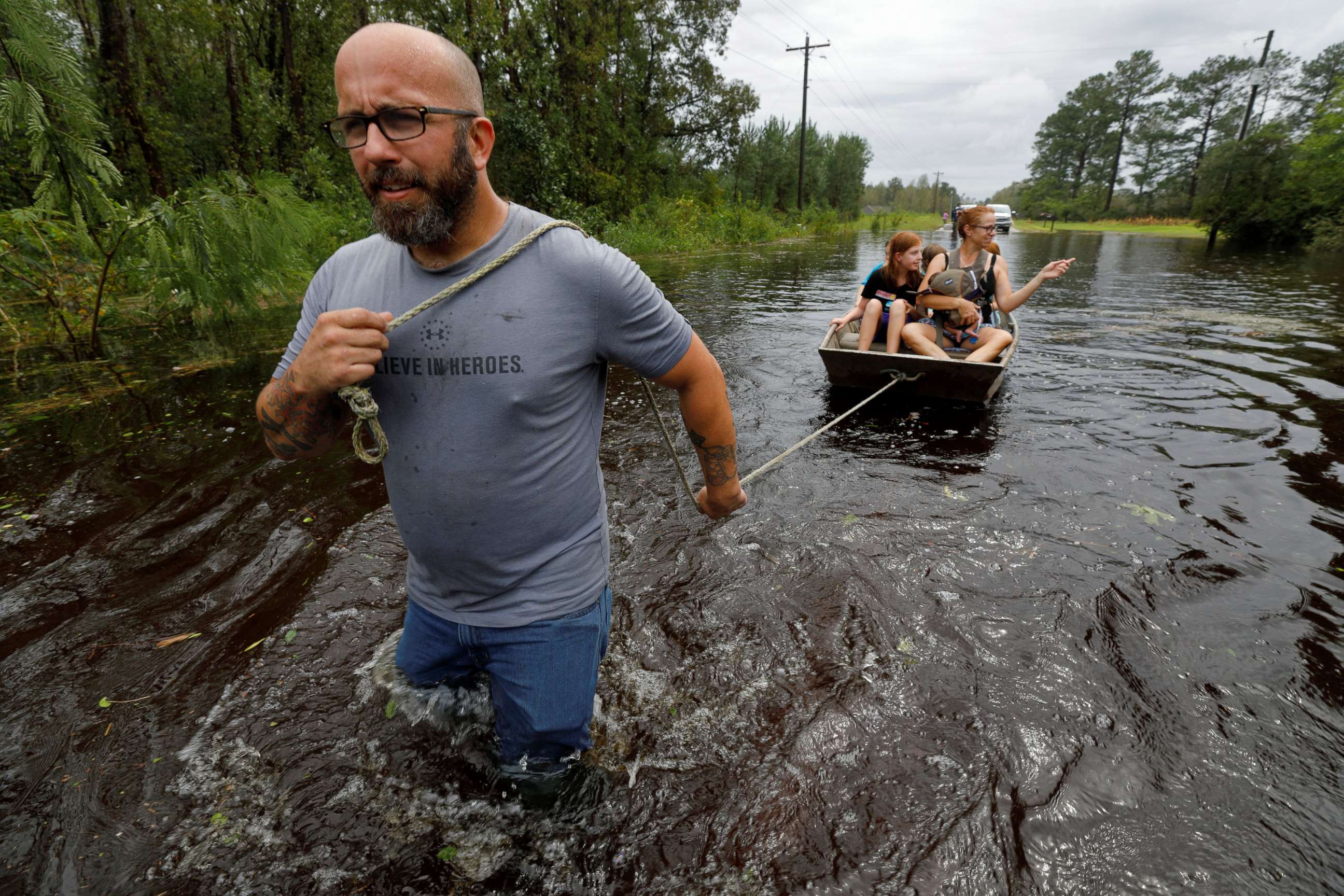 PHOTO: A volunteer from the community pulls a boat holding a mother and her children during their rescue from rising flood waters in the aftermath of Hurricane Florence, in Leland, N.C., Sept. 16, 2018.
