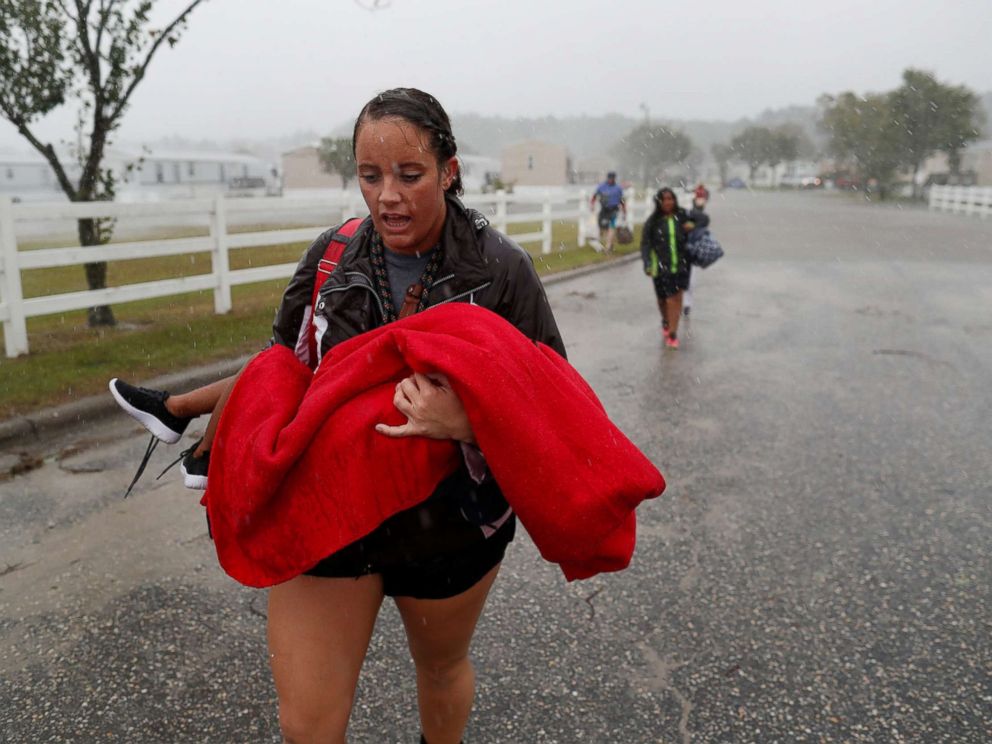 PHOTO: During a driving rain, Maggie Belgie of the Cajun Navy transports a child evacuating a community of trailers during Hurricane Florence in Lumberton, New Brunswick, on September 15, 2018.