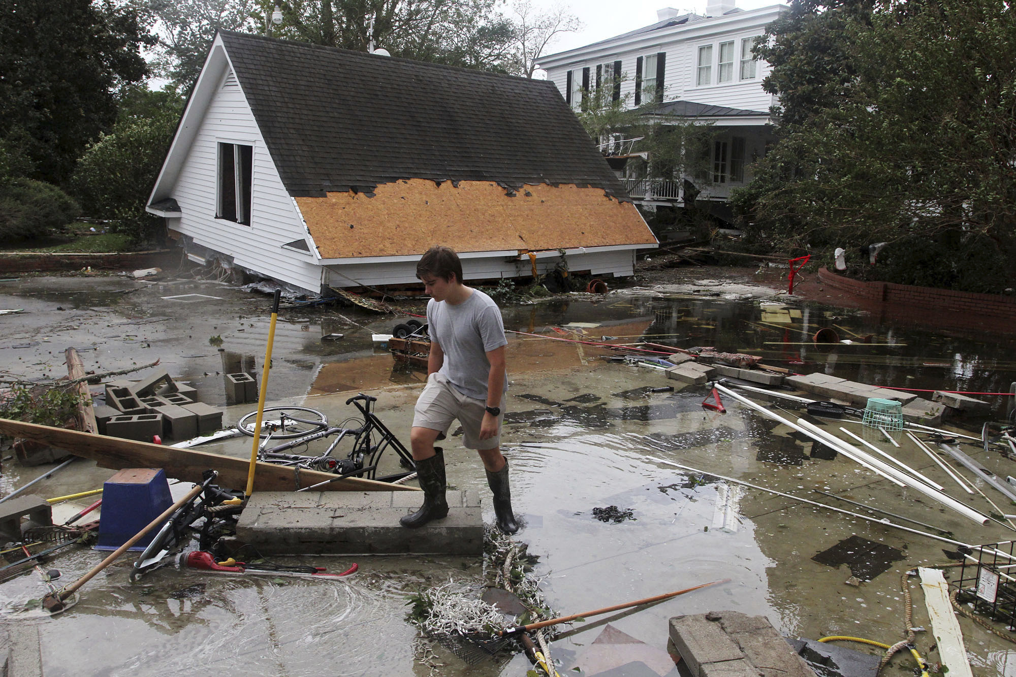 PHOTO: Joseph Eudi looks at flood debris and storm damage from Hurricane Florence at a home on East Front Street in New Bern, N.C., Sept. 15, 2018.