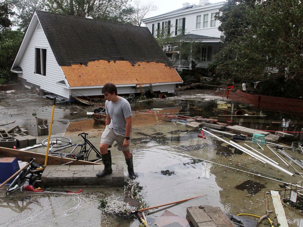 PHOTO: Joseph Eudi looks at flood debris and storm damage from Hurricane Florence at a home on East Front Street in New Bern, N.C., Sept. 15, 2018.