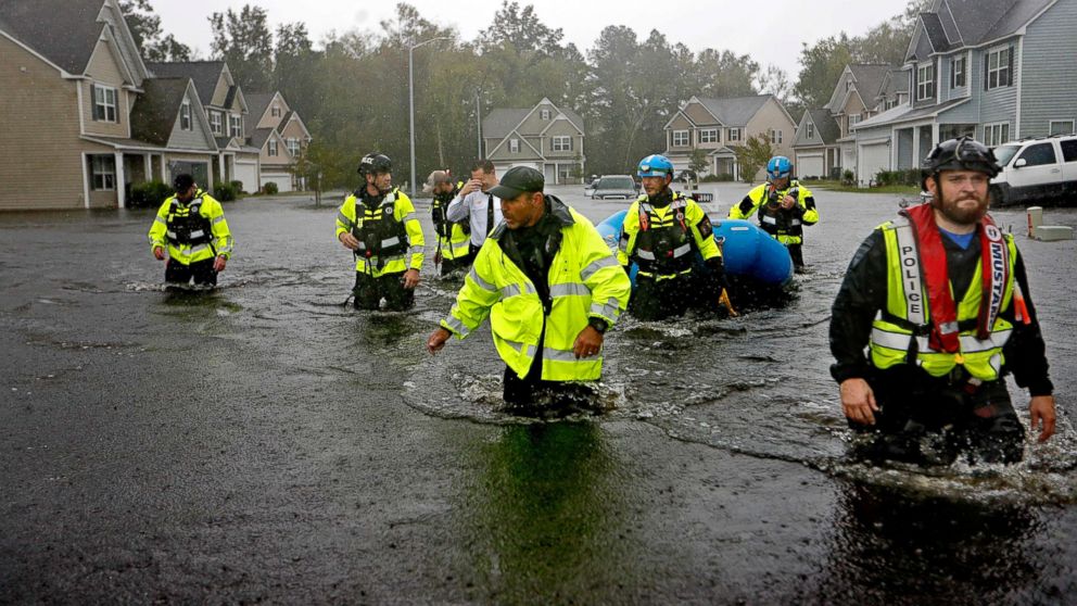 PHOTO: Members of the North Carolina Task Force urban search and rescue team wade through a flooded neighborhood looking for residents who stayed behind as Hurricane Florence continues to dump heavy rain in Fayetteville, N.C., Sept. 16, 2018.