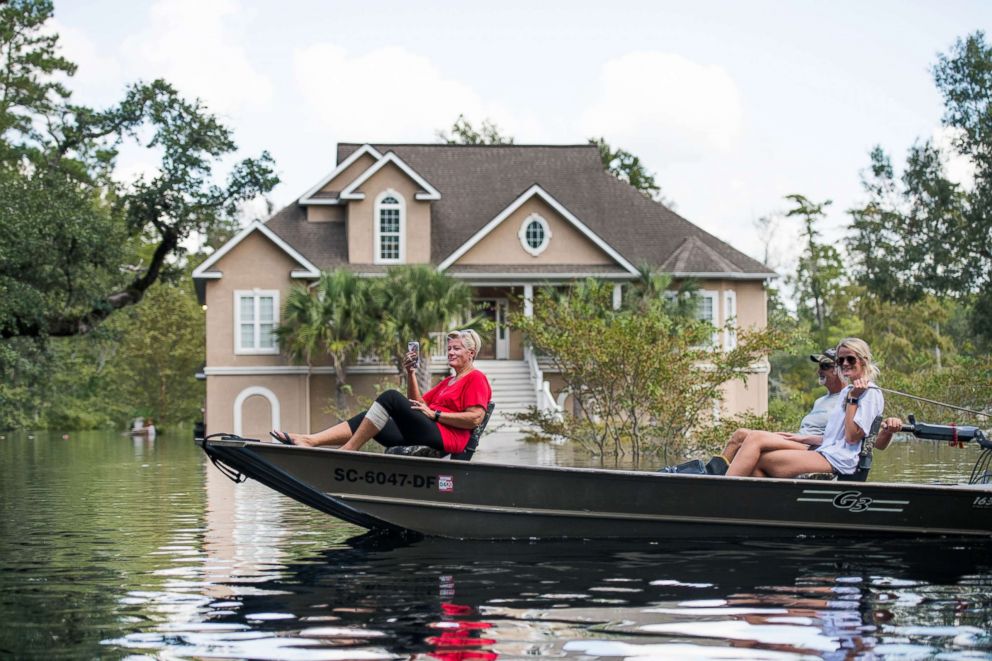 PHOTO: People navigate floodwaters caused by Hurricane Florence near the Waccamaw River on Sept. 23, 2018 in Conway, South Carolina.