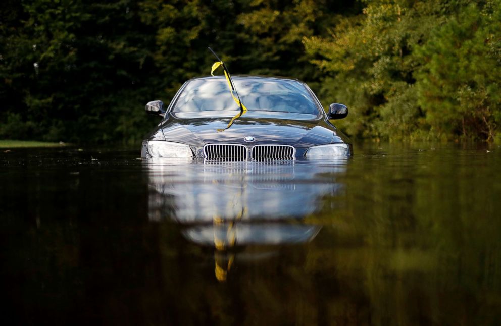 PHOTO: A car sits in a flooded parking lot at an apartment complex near the Cape Fear River as it continues to rise in the aftermath of Hurricane Florence in Fayetteville, Sept. 18, 2018.