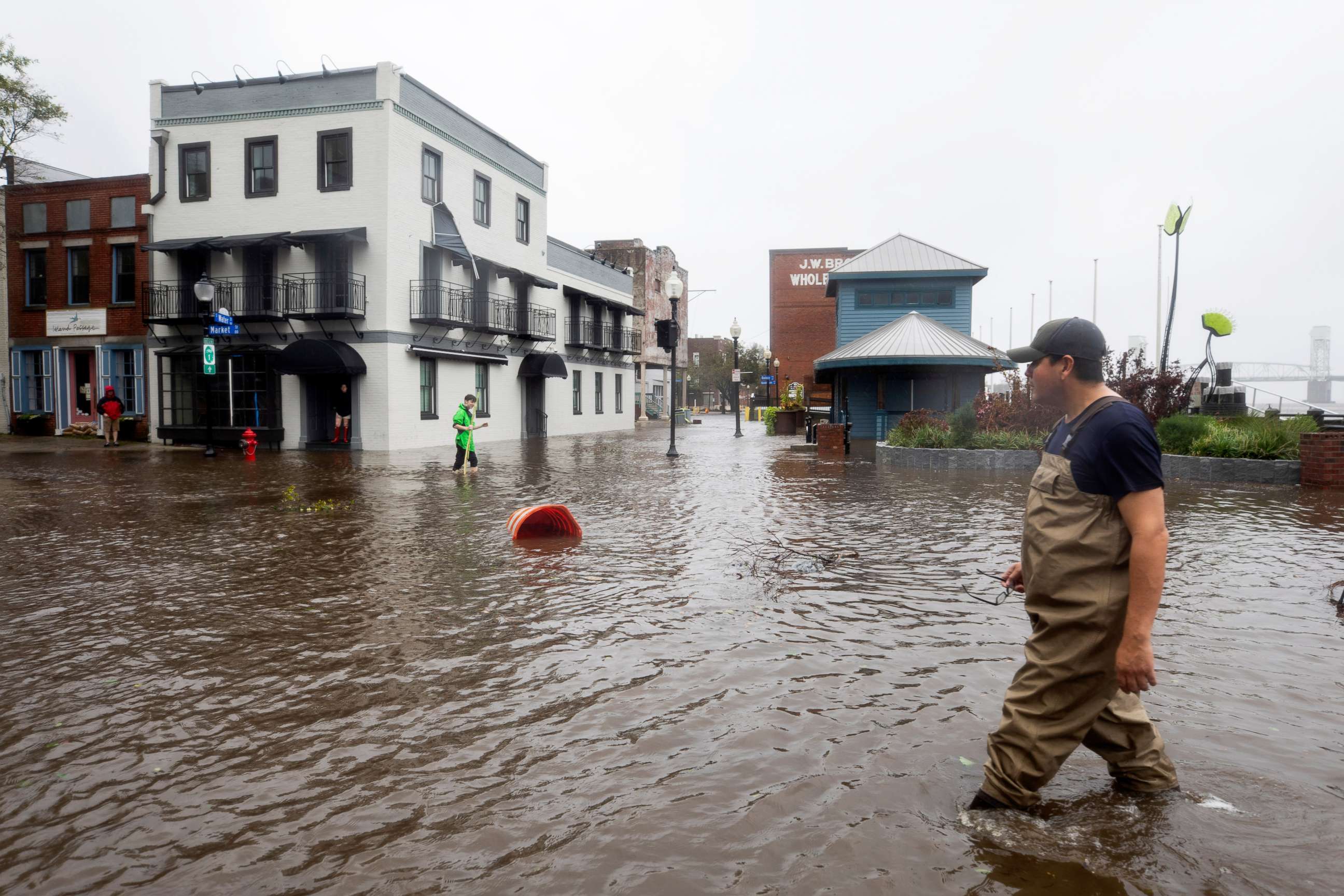 PHOTO: People walk through flooded Water Street as Hurricane Florence comes ashore in Wilmington, N.C., Sept. 14, 2018.