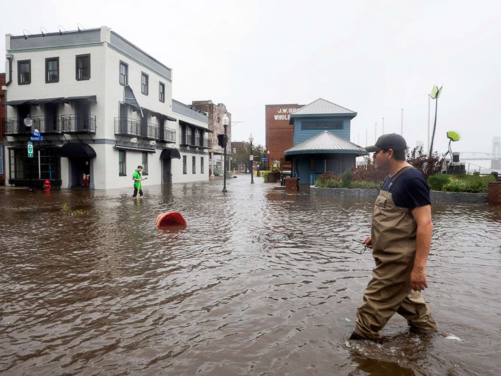 PHOTO: People cross flooded Water Street as Hurricane Florence lands in Wilmington, New Brunswick on September 14, 2018.