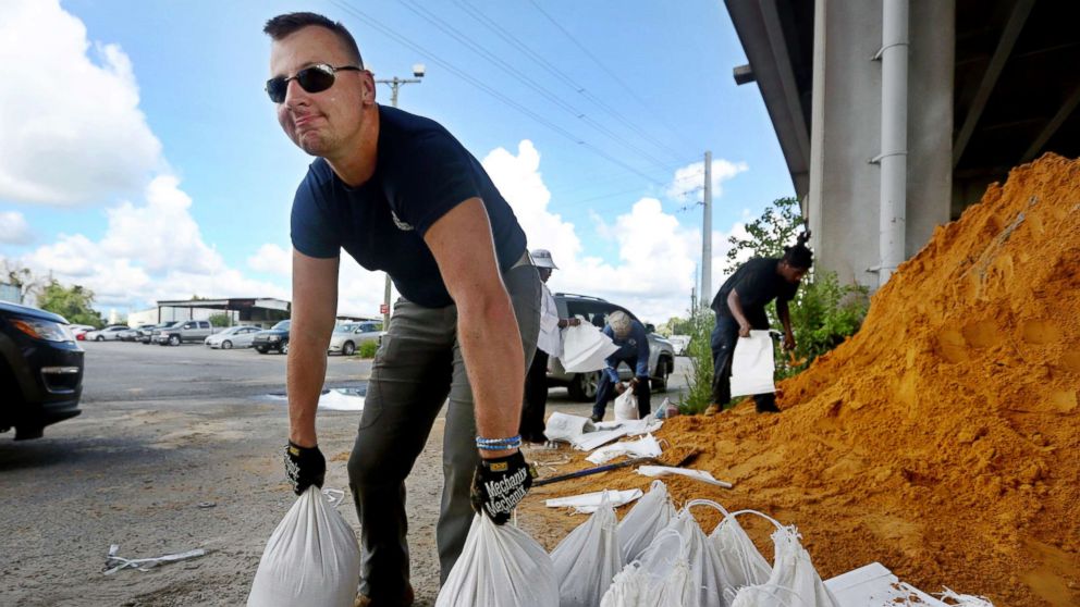 PHOTO: Kevin Orth loads sandbags into cars on Milford Street as he helps residents prepare for Hurricane Florence, Sept. 10, 2018, in Charleston, S.C.