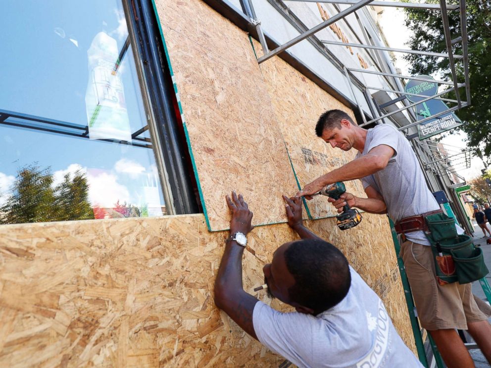 PHOTO: Workers are seen as they work to secure plywood ahead of the arrival of Hurricane Florence in Wilmington, North Carolina, Sept. 12, 2018.